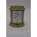 A good antique brass oval grande and petite sonnerie carriage clock, with alarm and push button