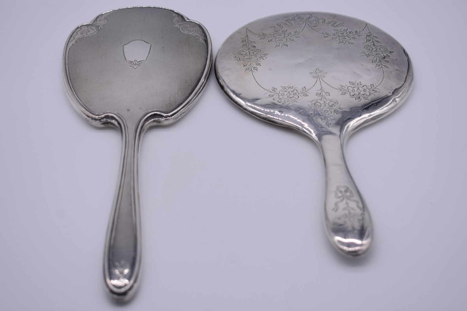 An engine turned silver hand mirror, by Adie Brothers Ltd, Birmingham 1963; together with one other.