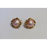 A pair of mabe pearl ear clips, stamped 585, 22mm