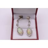 A pair of Art Deco teardrop opal and diamond pendant earrings, stamped 'plat', with later added