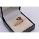 A cinnamon garnet and white sapphire dress ring, unmarked.
