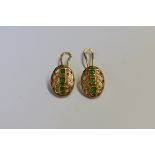 A pair of yellow metal oval emerald ear clips, stamped 18k, 1.7cm, 4.9g.