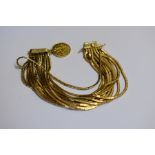 An 18ct gold 15 strand cable bracelet, import mark London 1965, having attached George Sovereign.