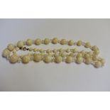 A graduated opal and rock crystal single strand necklace, having yellow metal clasp