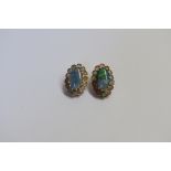 A pair of yellow metal opal doublet oval ear clips, stamped 14, 17.5mm, 5.8g gross.