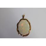 An opal oval pendant, in yellow metal mount, stamped 14ct, 4.3cm, 8.3g gross.
