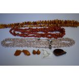 An amber necklace; together with a coral necklace; a natural freshwater three strand necklace