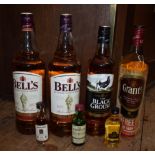 Four bottles of blended whisky, comprising: two 1 litre bottles of Bell's, (seal on one broken); a