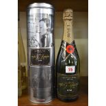 A bottle of Moet 1998 vintage Millesime Blanc champagne, in metal tin.
