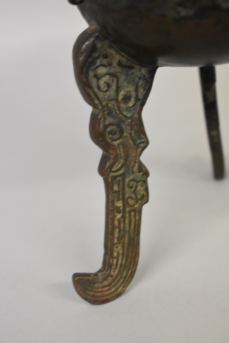 WITHDRAWN FROM SALE A Chinese Archiastic bronze twin handled tripod ding, with stylized decoration. - Image 3 of 6