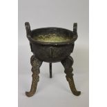 WITHDRAWN FROM SALE A Chinese Archiastic bronze twin handled tripod ding, with stylized decoration.