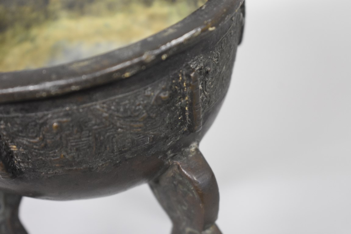 WITHDRAWN FROM SALE A Chinese Archiastic bronze twin handled tripod ding, with stylized decoration. - Image 5 of 6