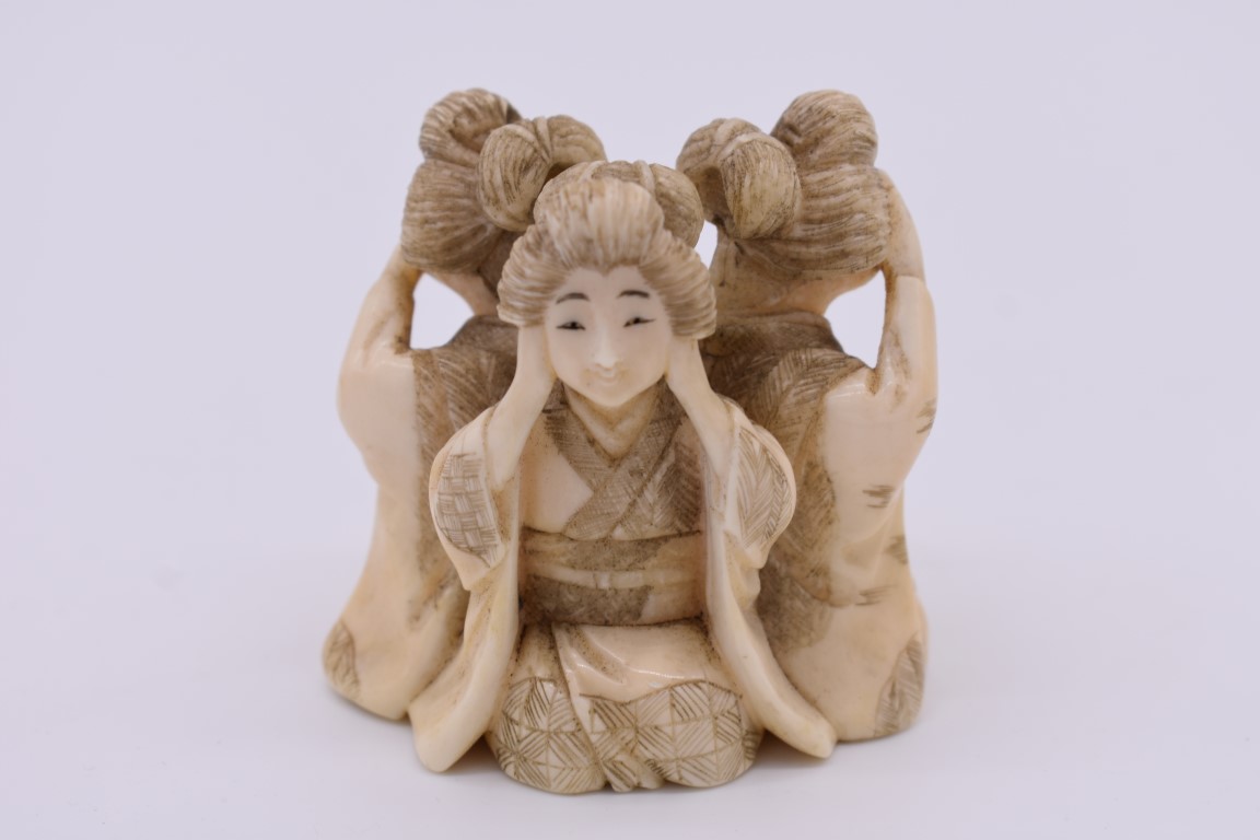 A Japanese carved ivory figure group of three geishas, Meiji, depicting 'see no evil, hear no