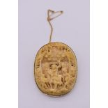 A Chinese carved ivory and 9ct gold mounted oval brooch, the whole 4.7 x 3.7cm.