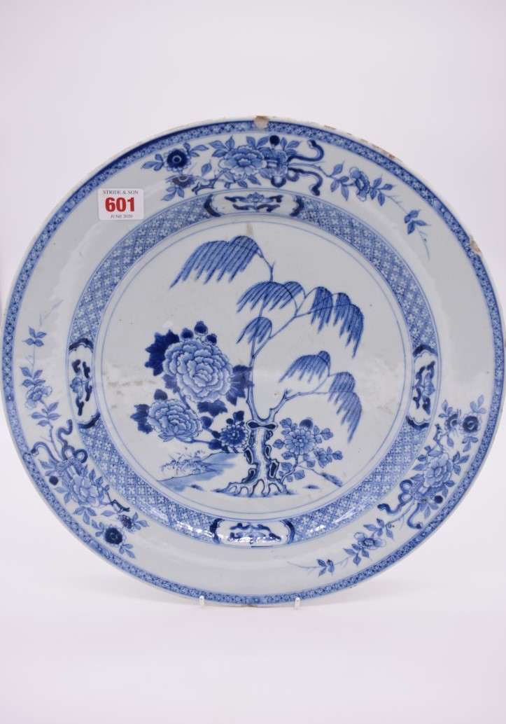 A Chinese blue and white charger, 18th century, painted with flowering branches, 37.5cm diameter, (