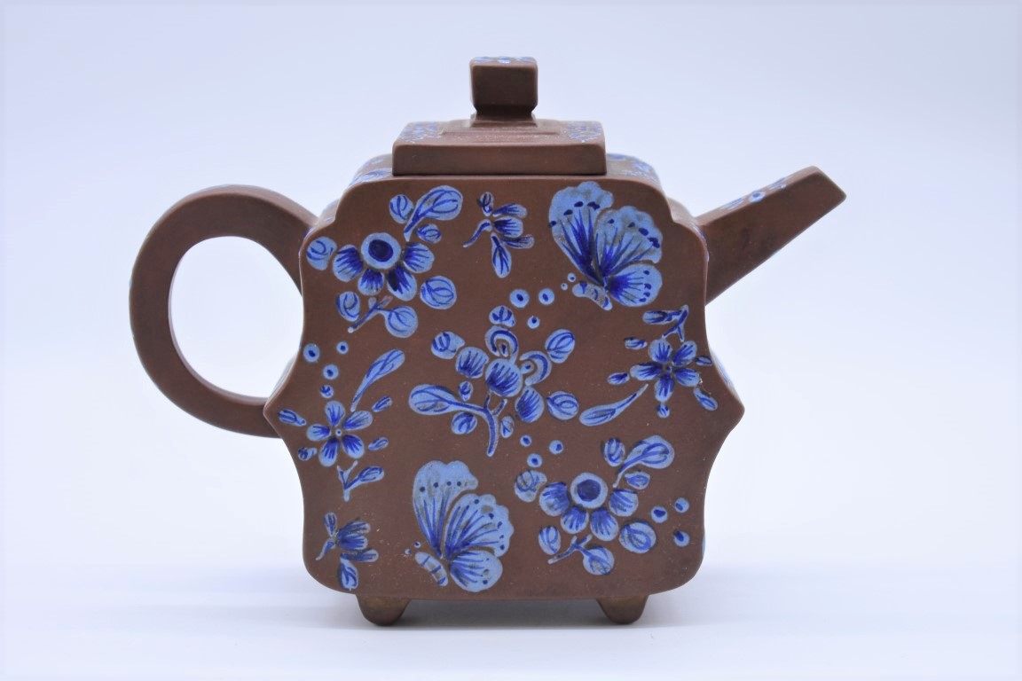 A Chinese yixing teapot and cover, seal mark to base, 19th century, enamelled with blue and white