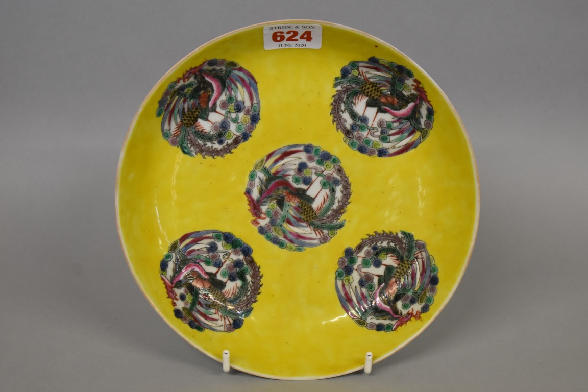 A Chinese yellow ground dish, Kangxi four character mark to base, painted with phoenix roundels,