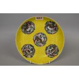 A Chinese yellow ground dish, Kangxi four character mark to base, painted with phoenix roundels,