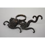 WITHDRAWN FROM SALE A Chinese bronze lingzhi dragon stand, with gilt eyes, 22.5cm wide.