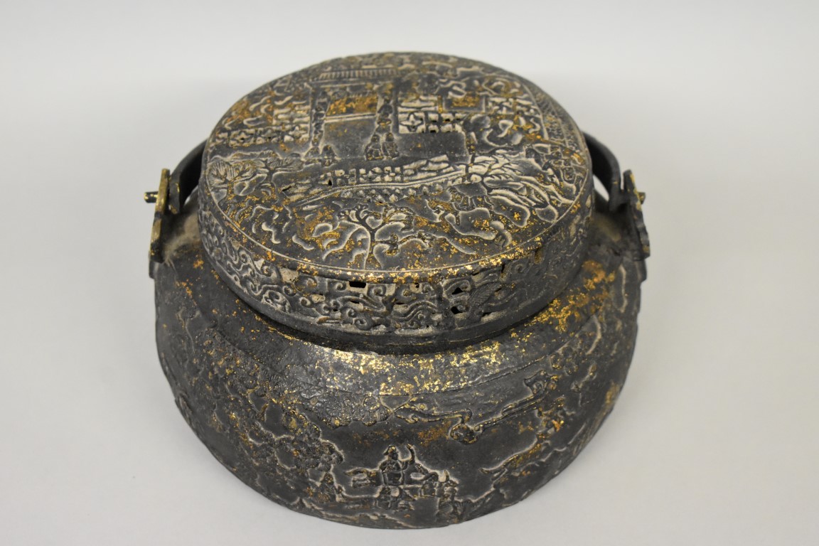 A Chinese bronze swing handled vessel and pierced cover, possibly a hand warmer, xuande four