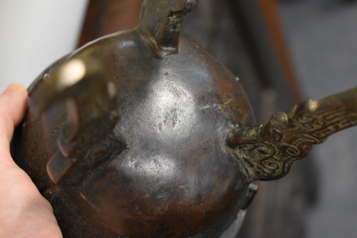 WITHDRAWN FROM SALE A Chinese Archiastic bronze twin handled tripod ding, with stylized decoration. - Image 6 of 6