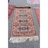 A Caucasian rug, having four medallions to central field with star decoration, with geometric and