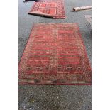 A Persian style rug, having allover geometric decoration on a red ground, 230 x 160cm.