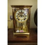 An Ansonia brass four glass mantel clock, with exposed escapement and mercury pendulum, 27.5cm high,