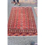 A Bokhara rug, having repeated medallions to central field, with geometric decoration to each end,