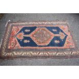 A Caucasian rug, central field decorated with four figures having geometric borders, 176 x 112cm.