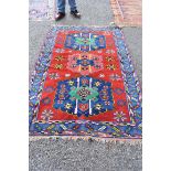 An Eastern rug, having three central medallions with floral decoration to central field, having