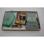 Of Masonic Interest: an antique pressed green glass bottle, 19cm high, together with four medals;