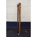 Angling: a Hardy bamboo rod tube, with leather cap; together with a carved bamboo walking/fishing