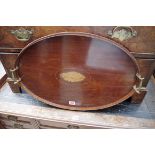 An Edwardian oval mahogany two handled gallery tray, inlaid shell to centre, 60cm.