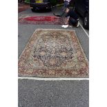 A machine made Persian style carpet, having allover floral decoration on a red and blue ground,