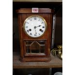 An oak striking mantel clock, by F M S, 32cm high, with pendulum and key.