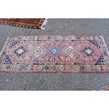 A small Persian style runner, having five central medallions, with geometric borders, 200 x 84cm.