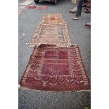 A Persian prayer rug, having floral decoration to border; together with two others.