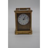 A small gilt brass carriage timepiece, having circular dial, height including handle 11.5cm, with