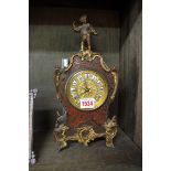 A Louis XV style boulle mantel clock, having figural surmount, 32cm high, with key.