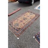 A Persian rug, having five central medallions, central field decorated with flowers and animals,