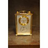 A vintage brass carriage type mantel clock, by Imhof, engraved presentation to rear door, total