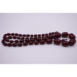 A string of graduated 'cherry amber' beads, 102cm, 100g.