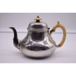 A Victorian silver teapot, by R & S Garrard & Co, London 1850, having ivory handle and finial,