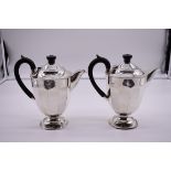 A pair of silver hot water pots by Viners, Sheffield 1936, 20cm high, 821g total weight.