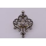 An Edwardian diamond floral brooch/pendant, the unmarked yellow metal and silver mount set Old