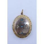 An oval locket set seed pearls and turquoise, 4cm.
