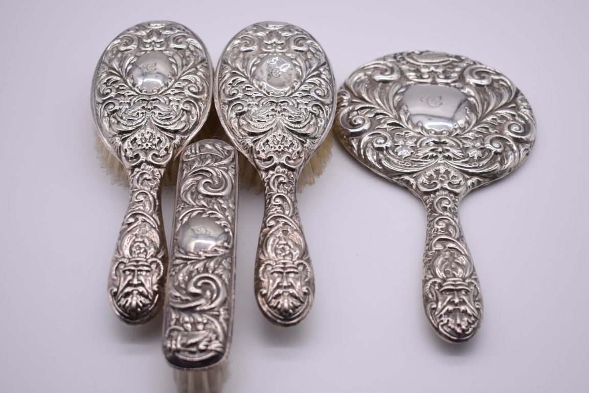 A four piece silver embossed dressing table set, by W I Broadway & Co, Birmingham 1963.