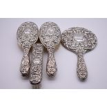 A four piece silver embossed dressing table set, by W I Broadway & Co, Birmingham 1963.