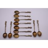 A part set of eleven Oriental metal spoons, having twisted snake handles, engraved 'Hong Kong 84'